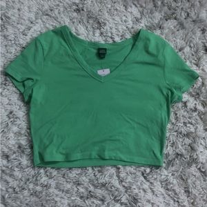 Light green cropped t shirt with a v-shaped neckline. Size- L Brand- Wild Fable